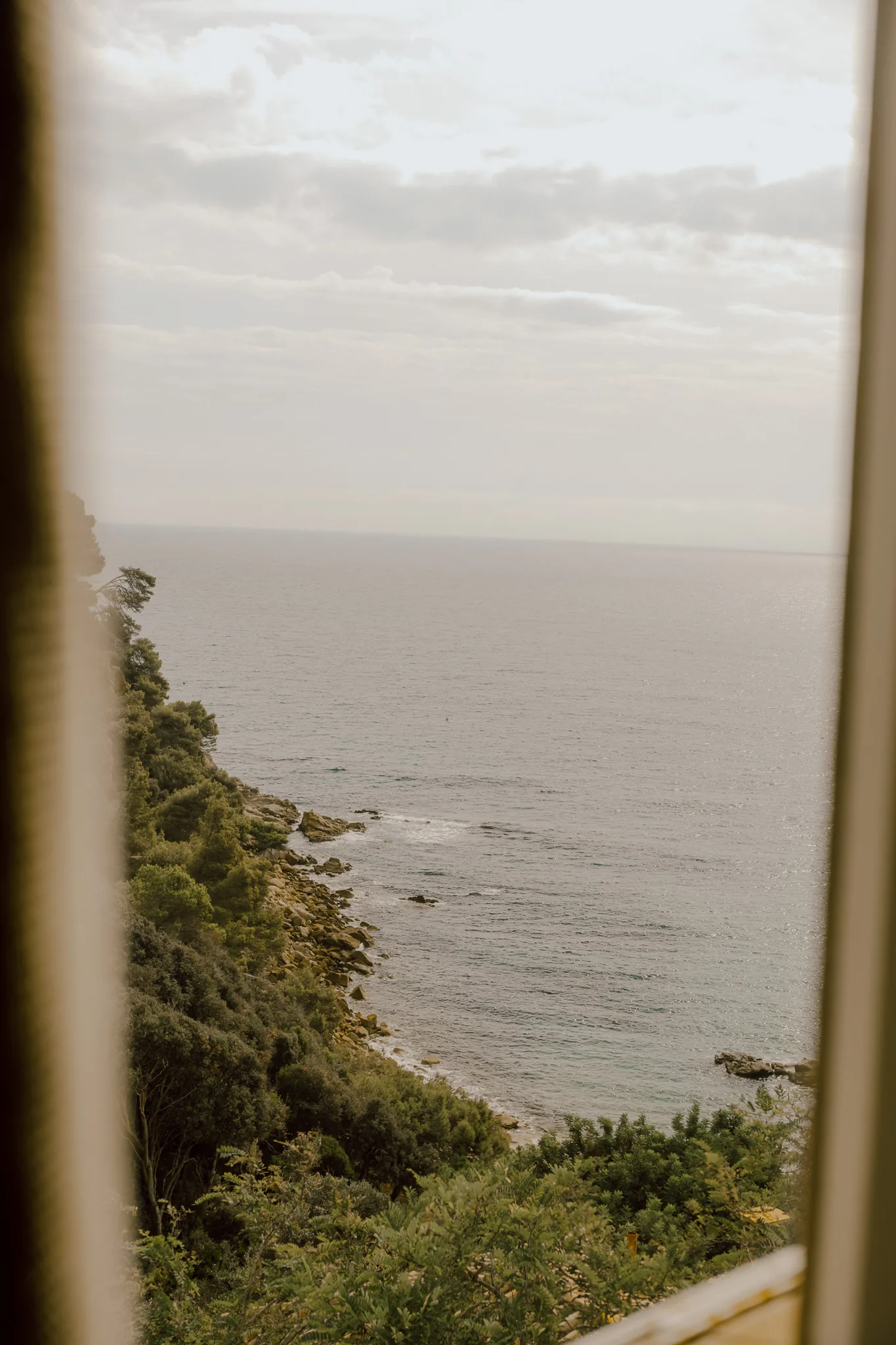 Mediterranean coastline seen through a window at Hotel Santa Marta